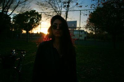 Young woman in park during sunset