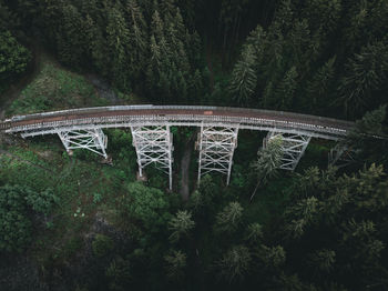 High angle view of bridge amidst trees in forest