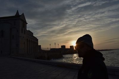 Silhouette of man in front of building