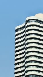 Low angle view of modern building against clear blue sky
