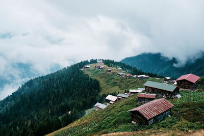 Aerial view of houses and trees against sky