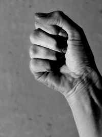 Close-up of person hand against wall