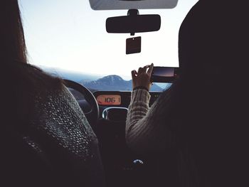 Woman driving in mountainous landscape