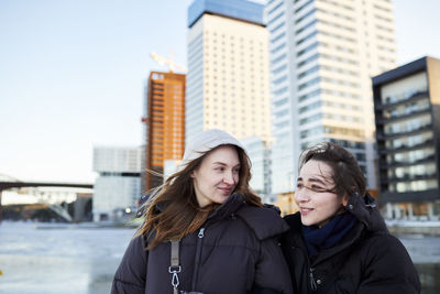 Smiling young women in modern neighborhood