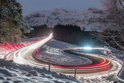 High angle view of light trails on road at night