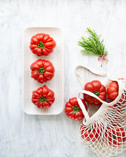 Still life of beautiful ripe tomatoes and rosemary.