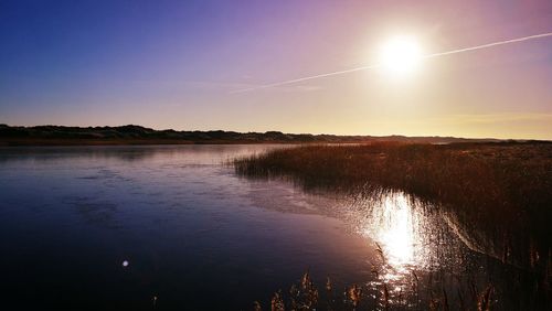 Scenic view of sunset over lake