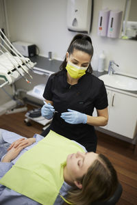 Female dentist with patient in office