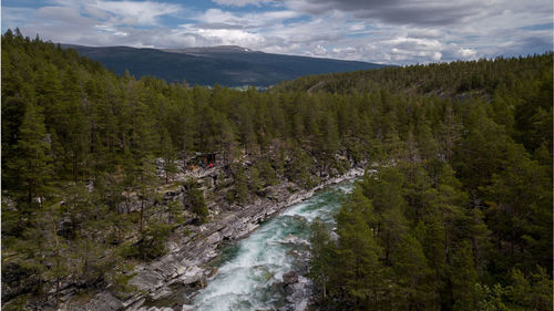 Scenic view of waterfall against sky