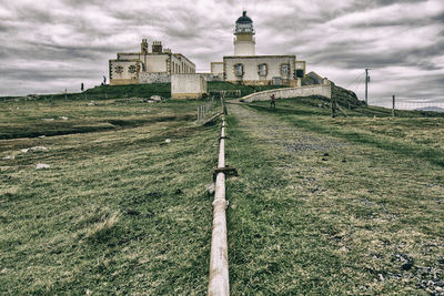 Old building on field against sky