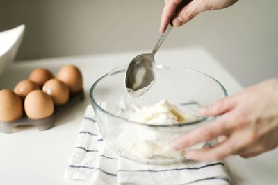 Midsection of man preparing food in kitchen