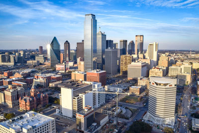 Aerial view of buildings in city against sky