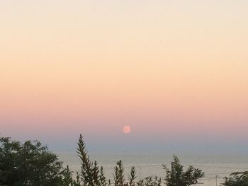 Scenic view of sea against clear sky at sunset