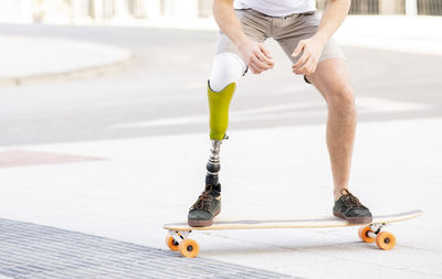 Low section of man skateboarding on skateboard