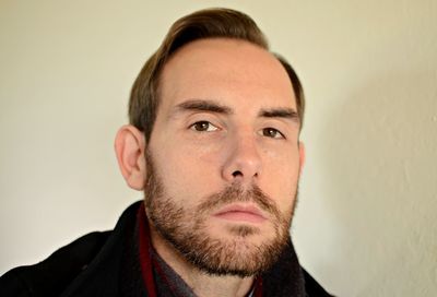 Close-up portrait of man against wall