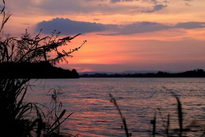 Scenic view of lake against romantic sky at sunset