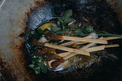 High angle view of meat on barbecue grill