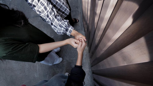 Low section of woman standing on staircase