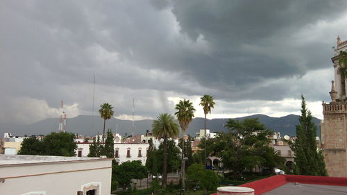 Houses against cloudy sky