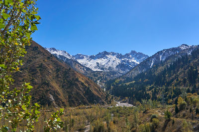 Scenic view of mountains against clear blue sky