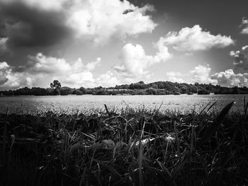 Scenic view of lake against cloudy sky