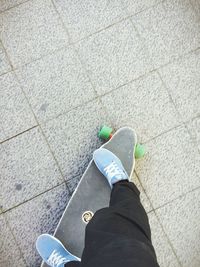 Low section of person standing on tiled floor