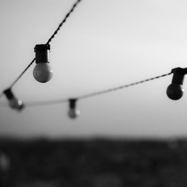 lighting equipment, electricity, close-up, cable, metal, hanging, connection, low angle view, focus on foreground, street light, wire, light bulb, technology, power supply, selective focus, no people, metallic, clear sky, copy space, electric light