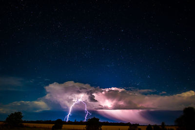 Low angle view of lightning against sky at night