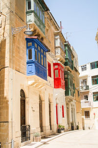 Low angle view of buildings in town against clear sky