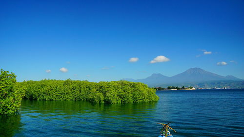 Scenic view of lake against blue sky