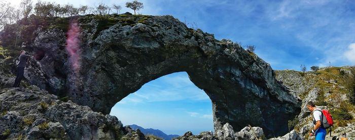 Low angle view of man on cliff against sky