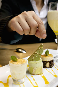 Businesswoman reaching for dessert at luxury hotel restaurant