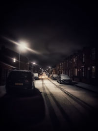 Cars on city street at night