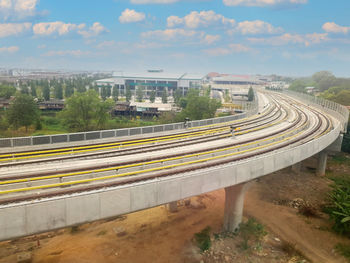 High angle view of railroad tracks in city against sky