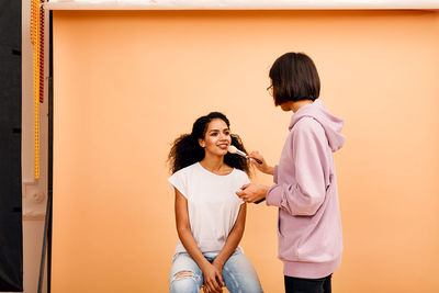 Woman standing against the wall