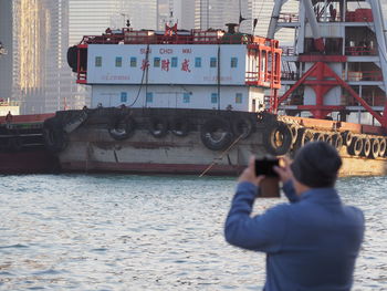 Rear view of man standing on boat