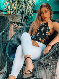 Portrait of young woman sitting on seat