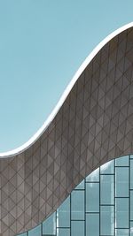 Low angle view of modern building against clear blue sky