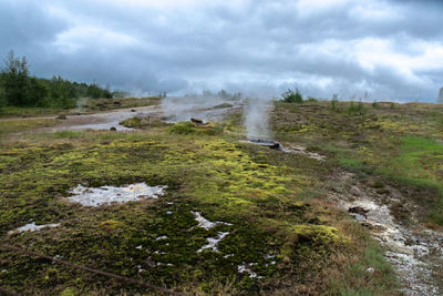 Scenic view of waterfall against sky