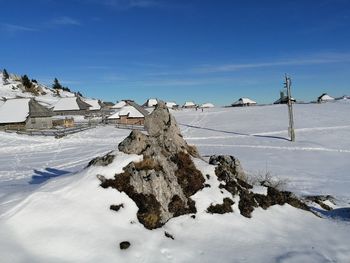 Snow covered field against sky