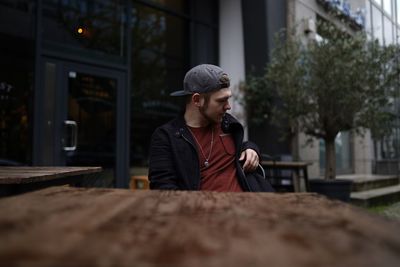 Man sitting at table in city