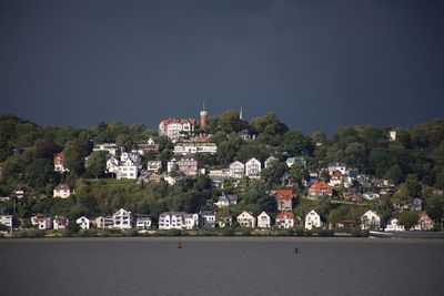 Town by buildings in city against sky