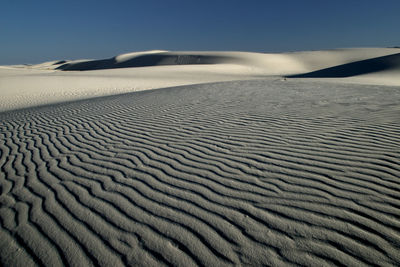 Sand dune in desert against sky