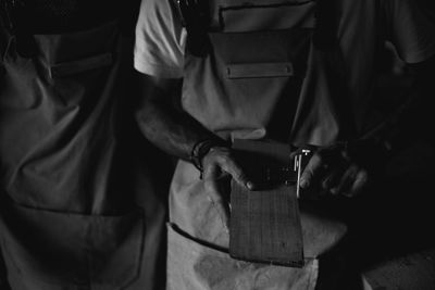 Midsection of carpenter working at workshop