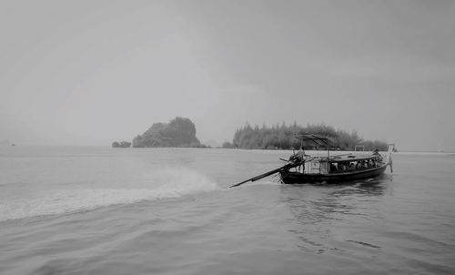 Boat sailing in sea against sky