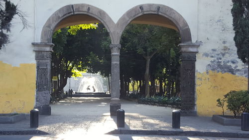 Street amidst buildings seen through arch
