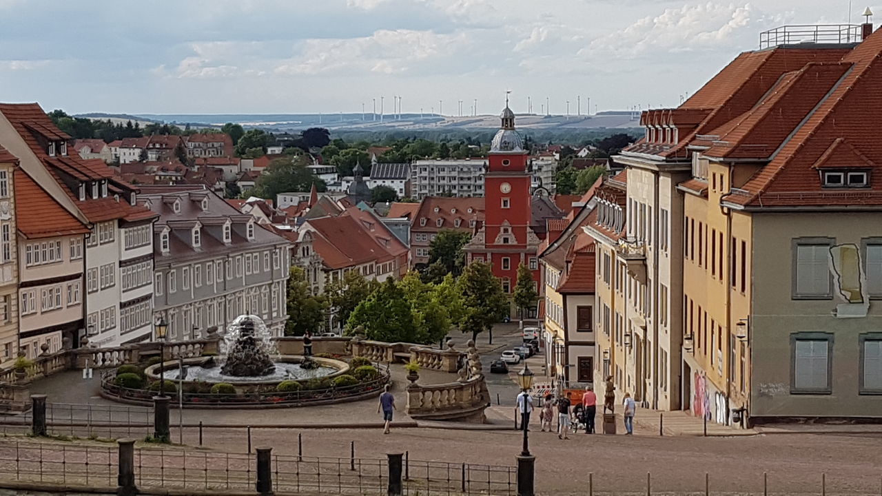 architecture, building exterior, built structure, sky, day, high angle view, outdoors, cloud - sky, place of worship, religion, travel destinations, large group of people, tree, water, nature, city, cityscape, people