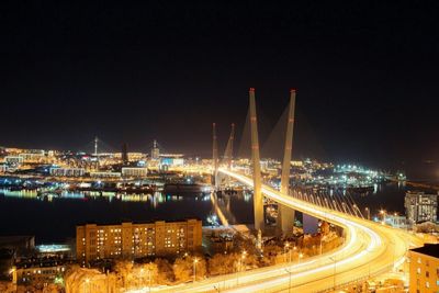 Illuminated cityscape against clear sky at night