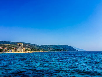 Scenic view of sea against clear blue sky