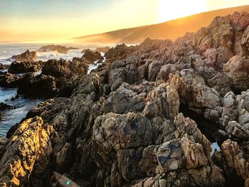 Scenic view of rocky mountains against sky during sunset